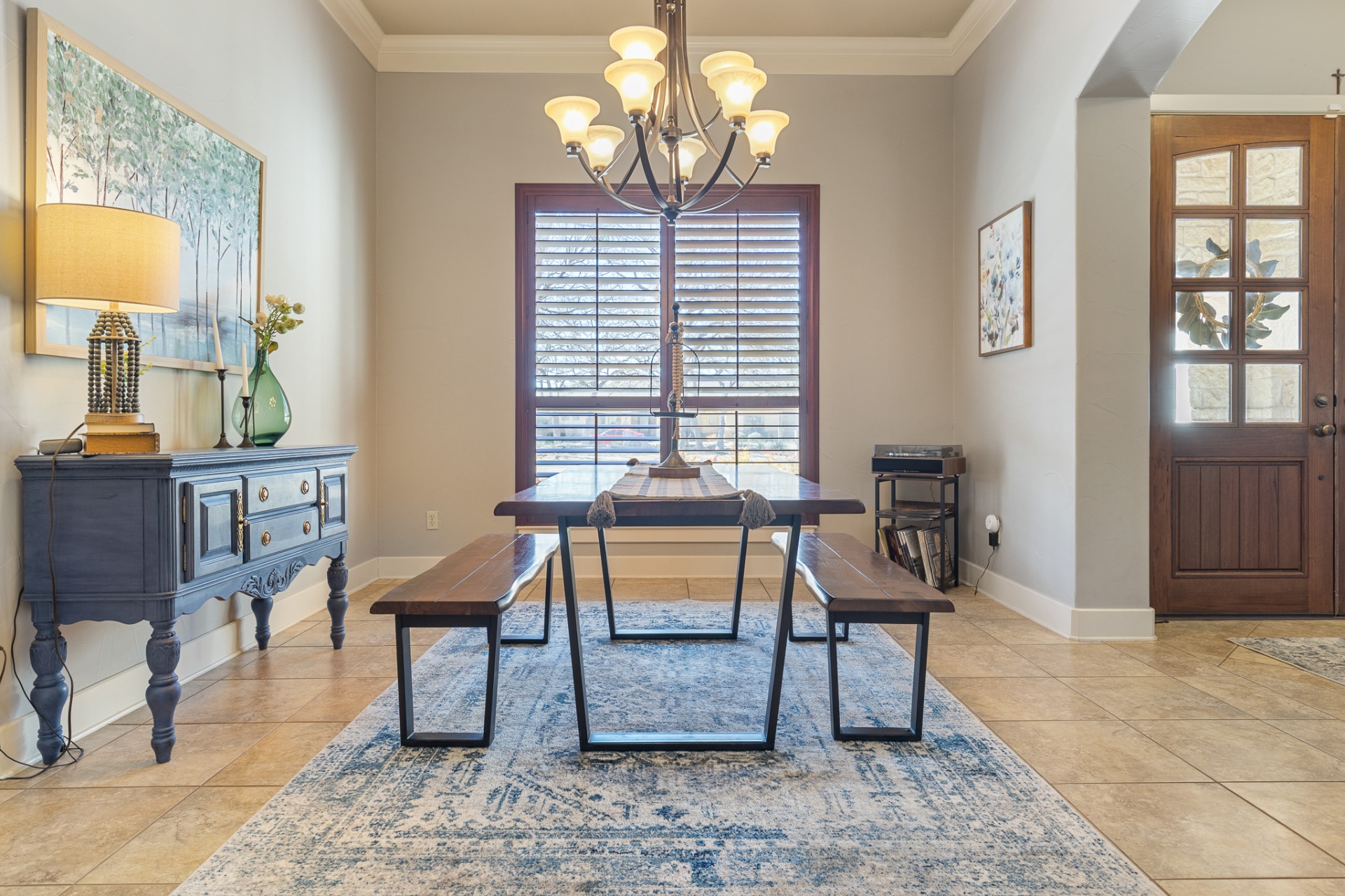 Formal dining room with chandelier and plantation shutters