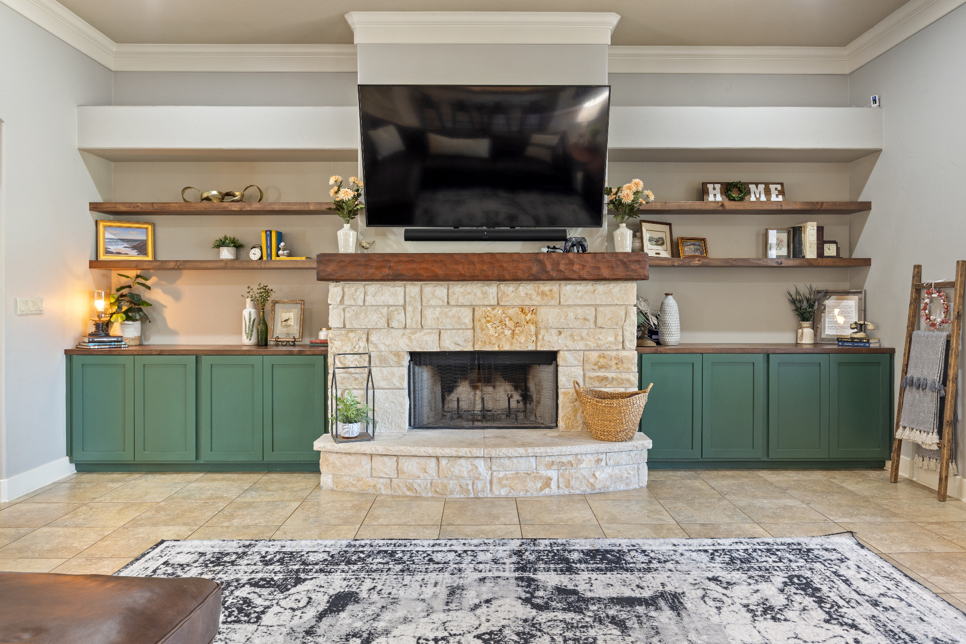Stone fireplace with custom wood mantel and built-in shelving