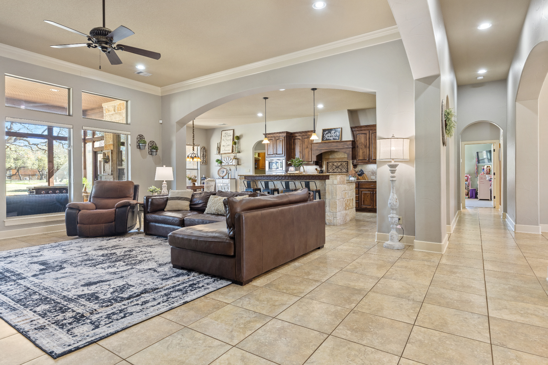 Open concept living room flowing into kitchen and hallways